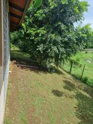 Bedroom with blue walls, large bed, window and wall lamps in El Carate house Las Tablas Panama