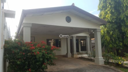Front exterior of single-family house with landscaped garden and driveway at Residencial Miramar Chitré Panama