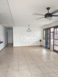 Traditional tiled living room with ceiling fan and glass doors in Residencial Miramar Chitré Panama
