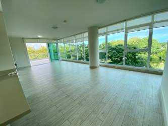 Living room with large windows, terrace access and greenery views in PH Solea Punta Barco Panama