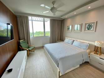 Modern furnished living-dining area with ocean view terrace in PH Solea Punta Barco beach apartment Panama