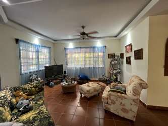 Traditional living room floral sofas ceiling fan large windows estate Chame Panama