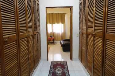 Walk-through closet wooden shutters corridor estate interior Altos de la Paz Panama