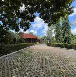 Large paved driveway lush gardens ranch home red roof Altos de la Paz Estate Panama
