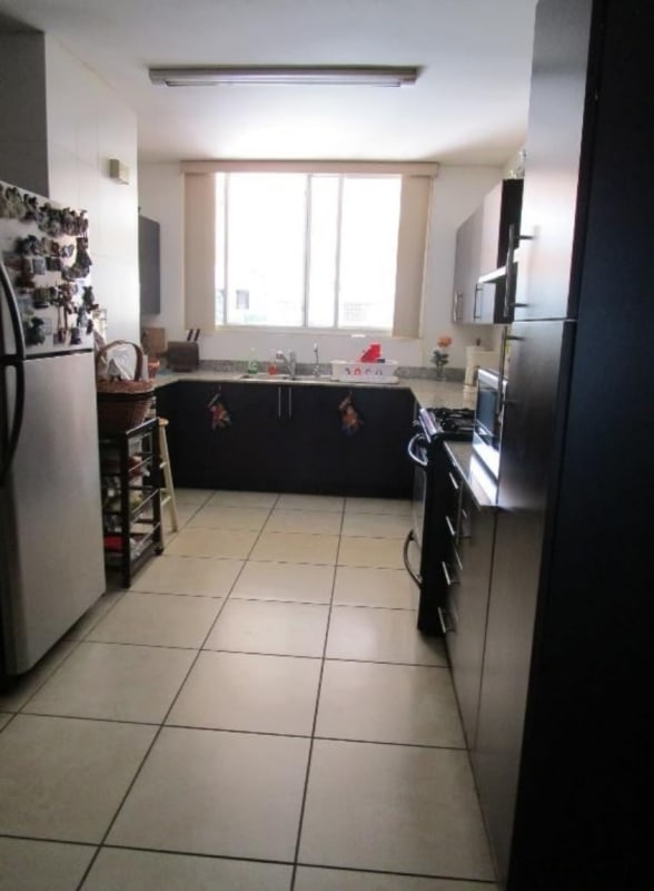 Covered outdoor terrace with terracotta tiles and garden view in Brisas Heights Panama