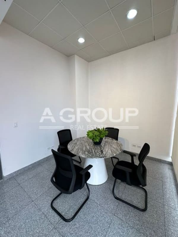 Small meeting room with marble round table black chairs minimal design PH Habitats Plaza Obarrio Panama