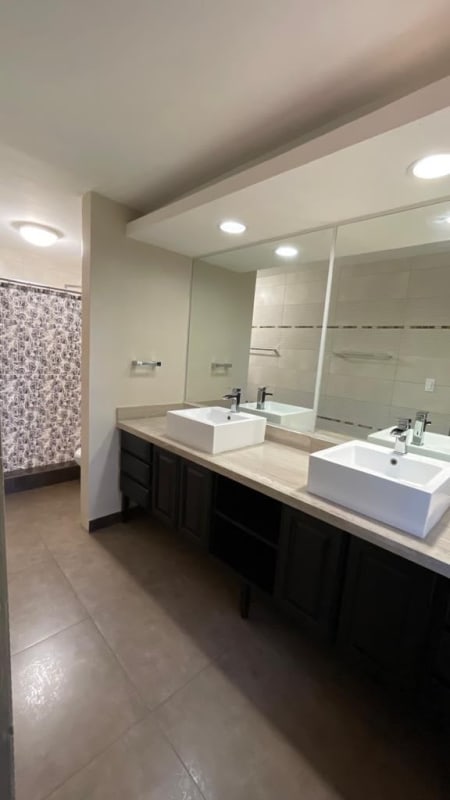 Empty bedroom with ceiling fan wooden floor and closet in Condado del Rey Panama