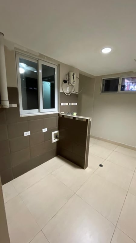 Open spacious living room with wooden flooring ceiling fans and dining area in Panama duplex house