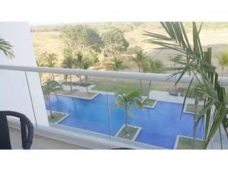 Bright living dining area opening to balcony with ocean views at Oceans II Playa Blanca Panama
