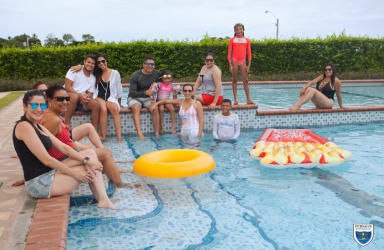 People enjoying sunny day by an outdoor pool with inflatables in Valle Village El Espino Panama
