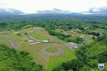 Aerial view residential plots, roundabout, hills backdrop in Valle Village Panama
