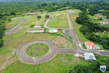 Aerial view of residential development with sports courts, pool, roundabout in Valle Village Panama