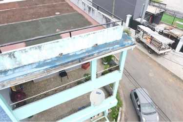 Corner view of multi-family residential building with balconies and parking Barrio Colón La Chorrera Panama