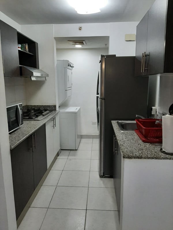 Bright living dining space with balcony access and city view at PH Parque Lefevre Panama