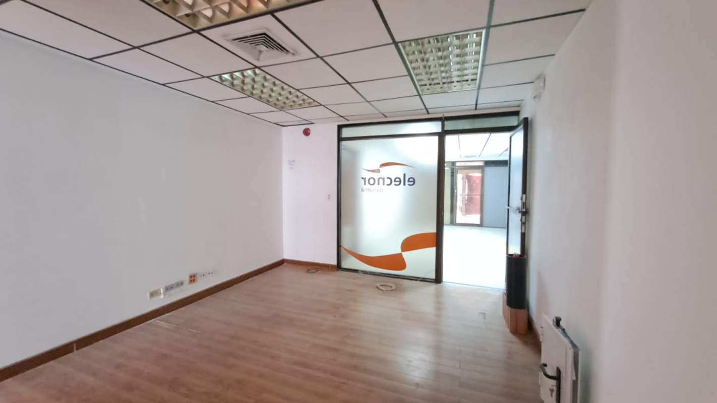 Empty office space with glass divider wooden floors and drop ceiling Edificio Vallarino Panama