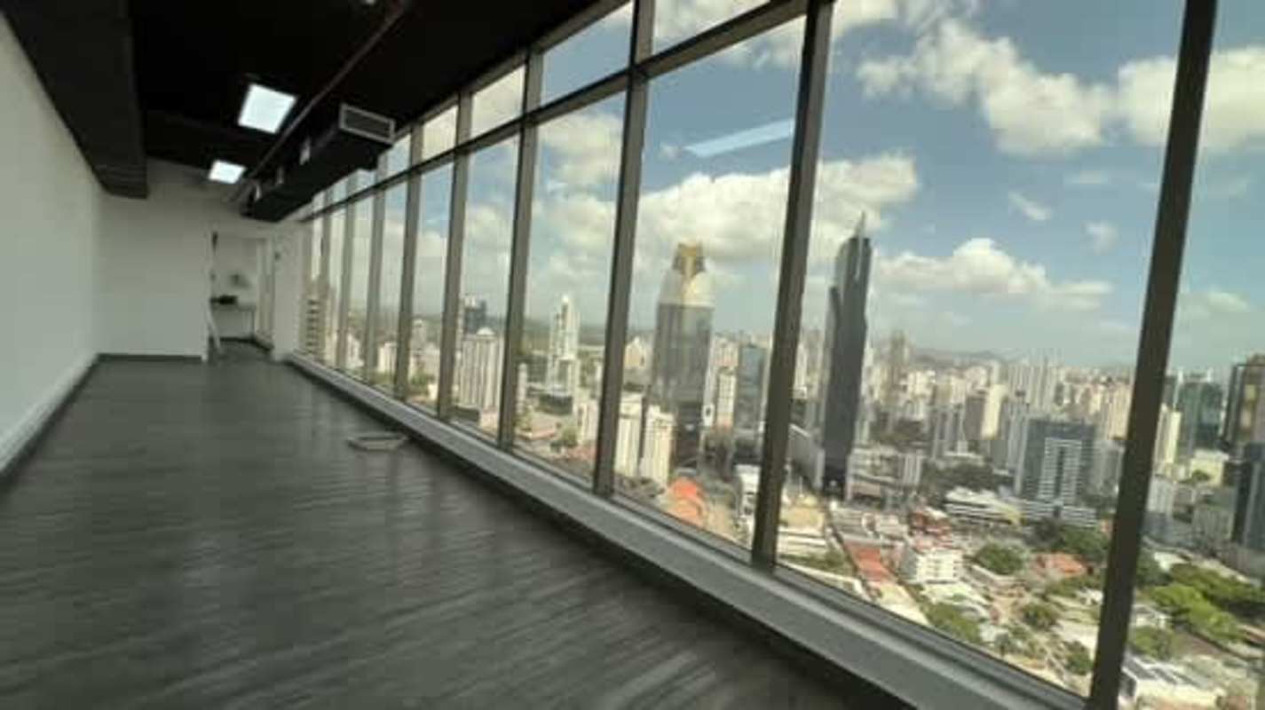 Bright modern office featuring glass partitions and ocean views at PH BICSA Tower