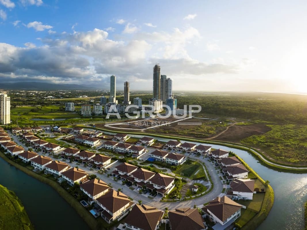 View of high-rise towers and open land in Santa María Country Club Panama City