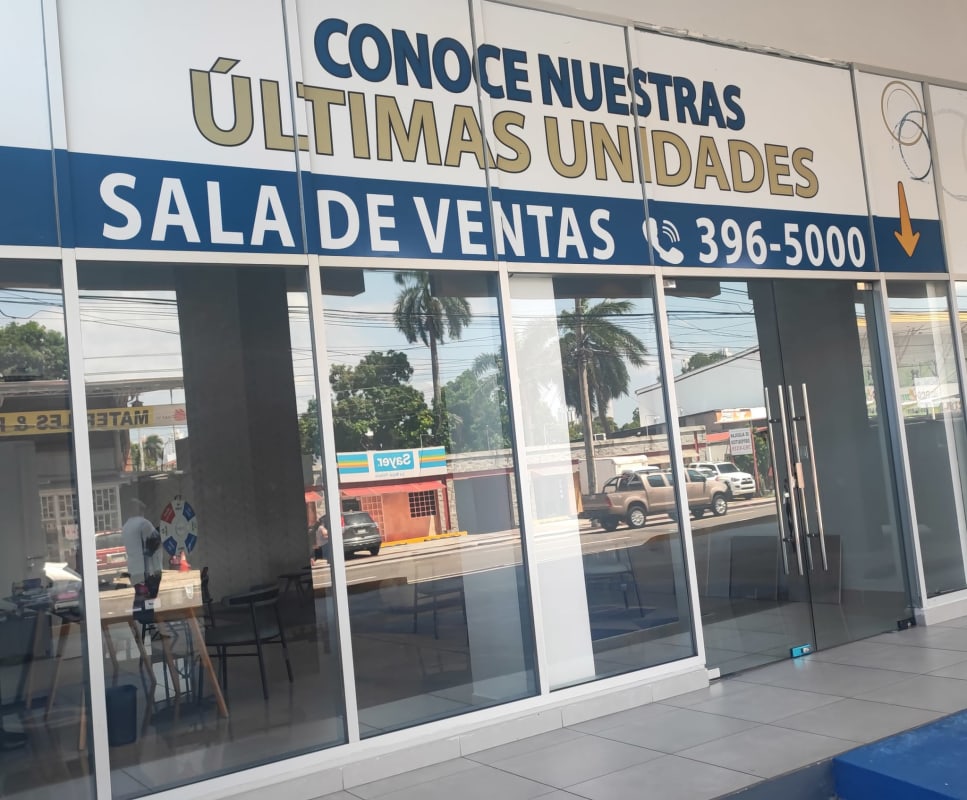 Modern glass entrance with promotional signage commercial showroom Época Plaza Panama