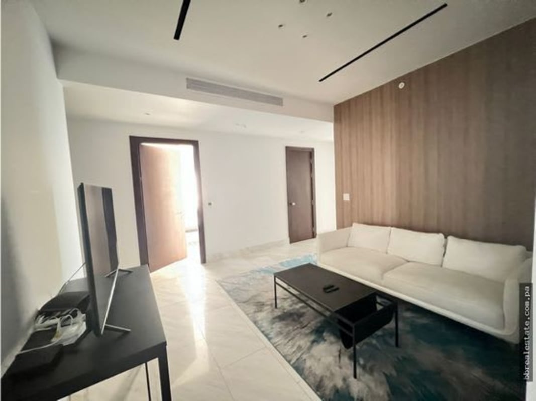 Modern gourmet kitchen with marble countertop island and stainless appliances at PH The Towers Punta Paitilla