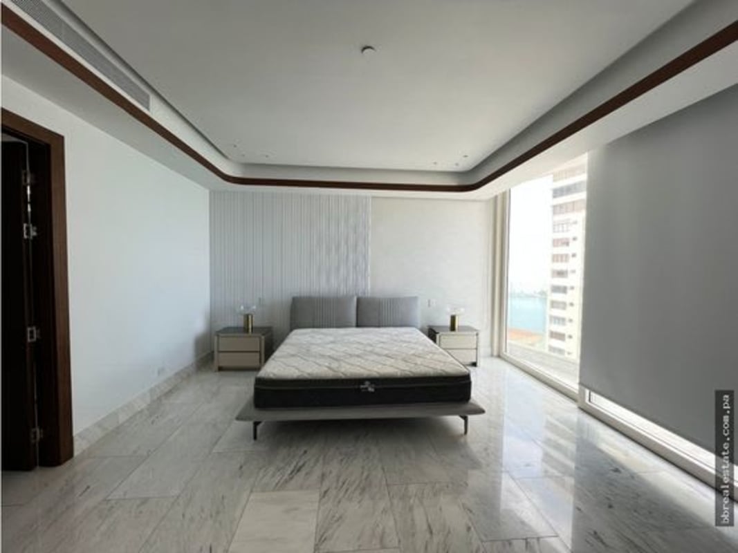 Bright bedroom with floor-to-ceiling windows and panoramic ocean views in PH The Towers Panama