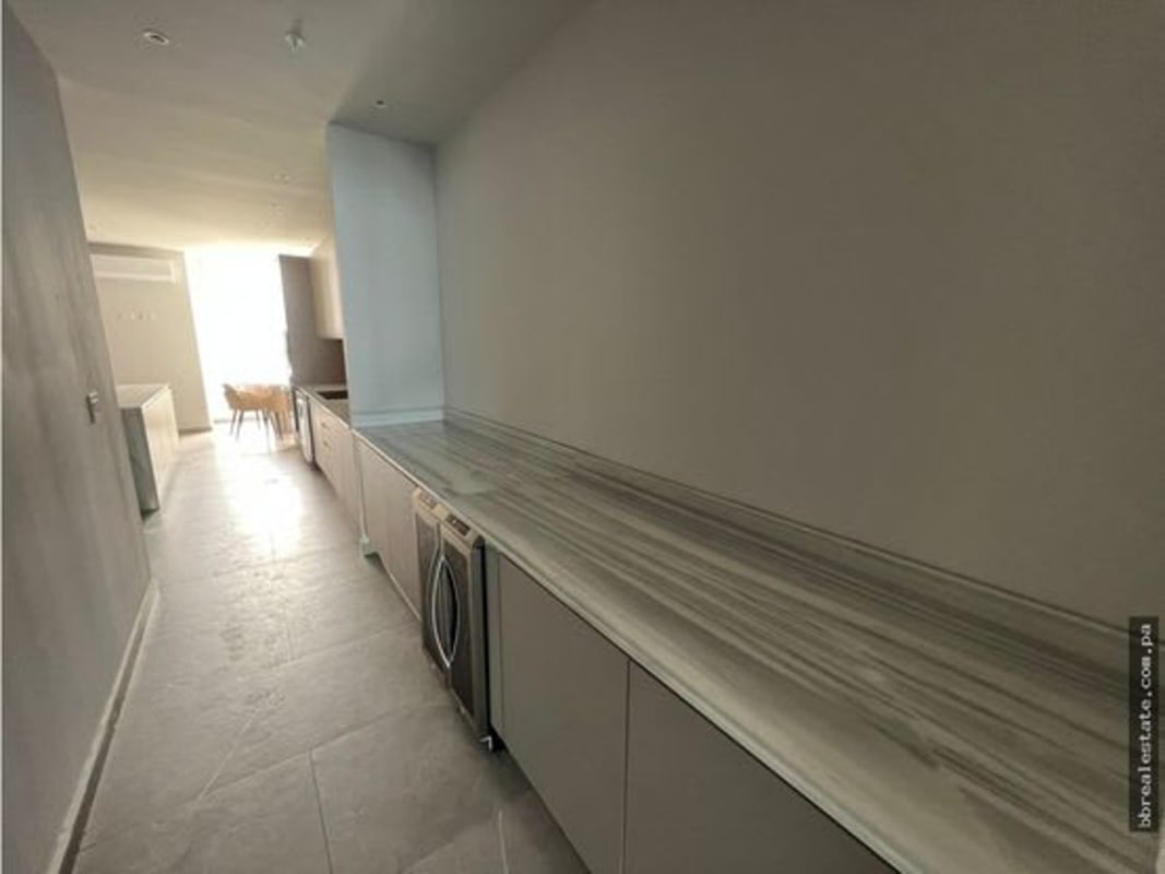 Spacious custom walk-in closet with central island and shelving at PH The Towers Panama