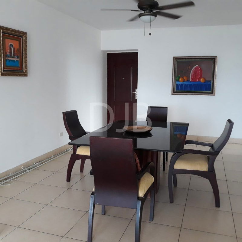 Dining room with glass table, ceiling fan, natural light at PH San Francisco Tower Panama City