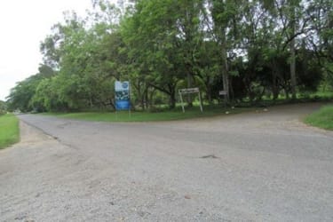 Paved road access and signage near large residential lot in Santa Clara Coclé Panama
