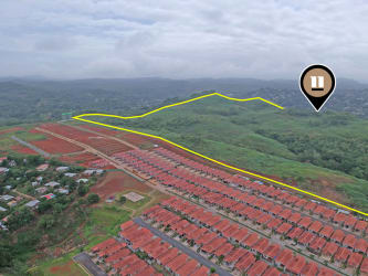 Large residential housing complex beside available green development plot Arraijan