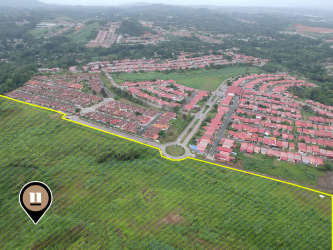 Cluster of red-roofed homes beside green undeveloped land parcel in Arraijan Panama