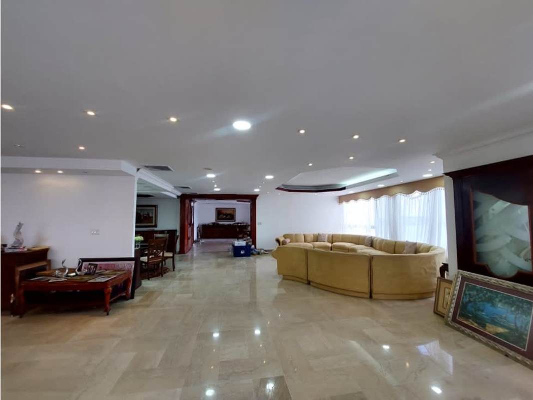 Living room with curved sofa panoramic window and skyline views at Bayside Tower Panama