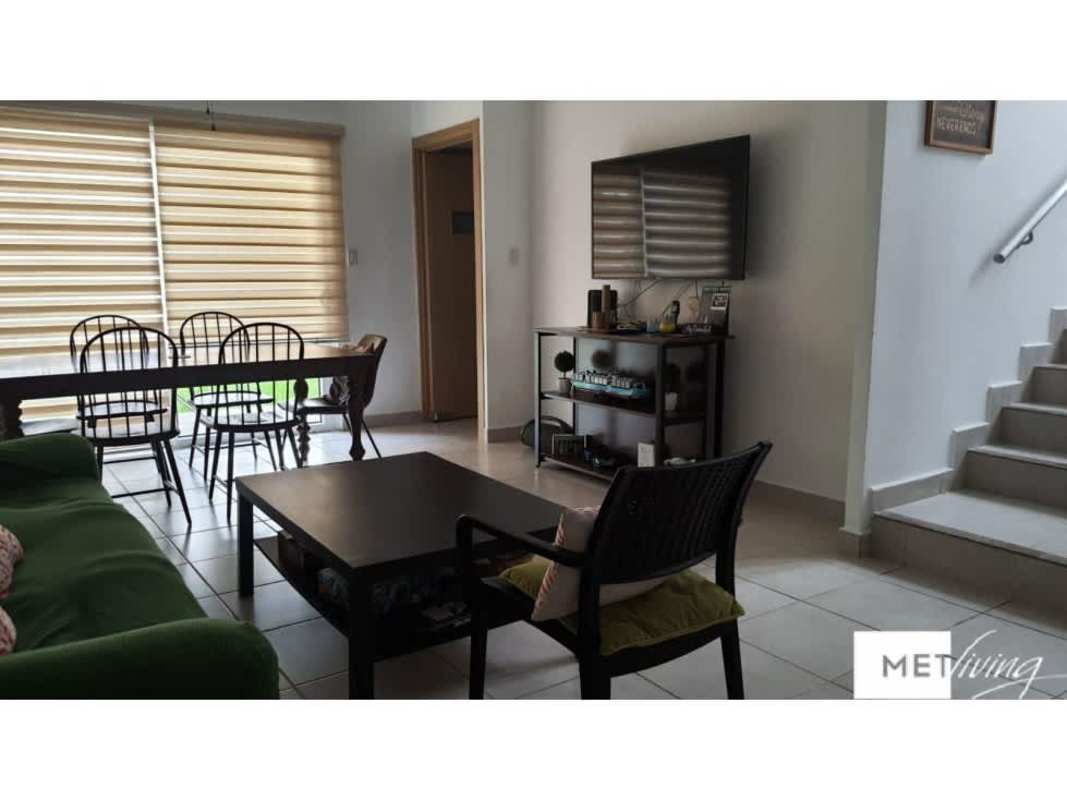 Modern open plan living and dining with green sofa in PH Victoria Brisas del Golf Panama