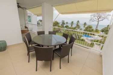 Spacious balcony with outdoor dining set overlooking ocean in Bijao Beachfront Condo Panama