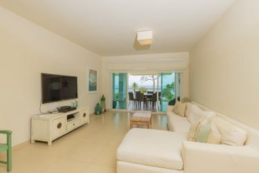 Bright living room with sliding glass doors opening to ocean view terrace in PH Balboa II Bijao Panama