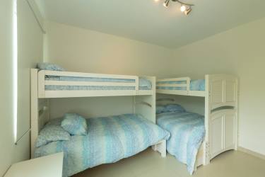 Large master bedroom with tile floors, glass doors to balcony and sea view in PH Balboa II Bijao Panama