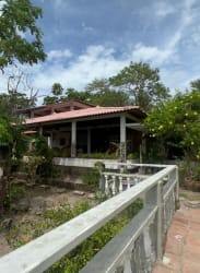 Traditional bathroom with burgundy tiles and fixtures in Costa Esmeralda house San Carlos Panama