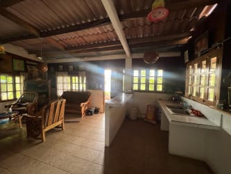 Rustic covered patio with dining wooden table and benches at Costa Esmeralda San Carlos beach house Panama