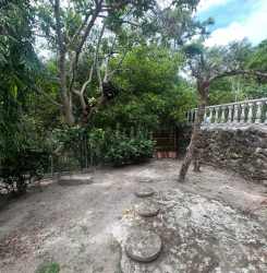 Bedroom with rustic wooden bunk beds, tile floor, wood ceiling at Costa Esmeralda San Carlos Panama