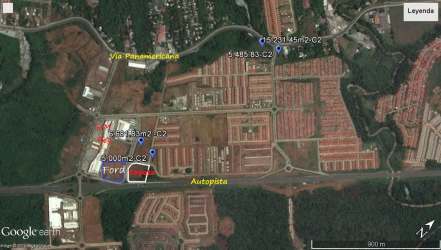 Aerial view of highway-accessible commercial land surrounded by residential and green zones in La Chorrera Panama