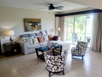 Bedroom with balcony access and garden views in Villas Decameron Rio Hato Panama