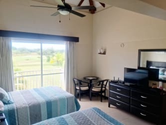 Bright staircase area with large windows inside beach house Villas Decameron Panama