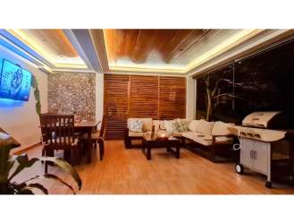 Cozy indoor lounge with wooden ceilings, stone walls and garden views in Altos del María