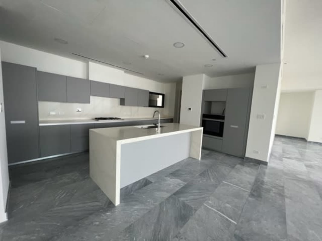 Modern chef kitchen large island marble countertops built-in appliances Upper East Tower Panama