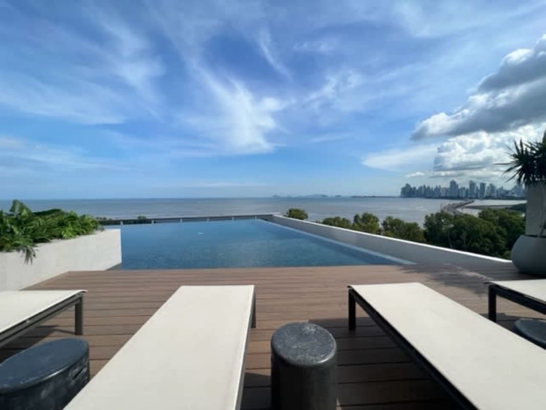 Luxury infinity edge pool facing Panama City skyline ocean Upper East Tower Panama