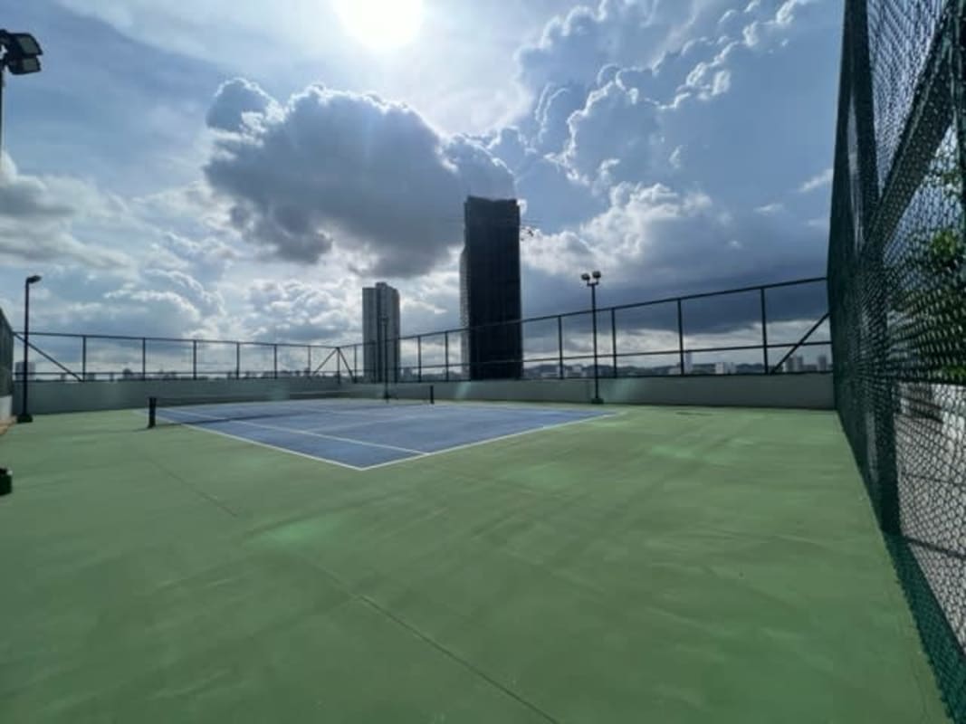 Rooftop tennis court with fencing overlooking Panama City skyline Upper East Tower Costa del Este