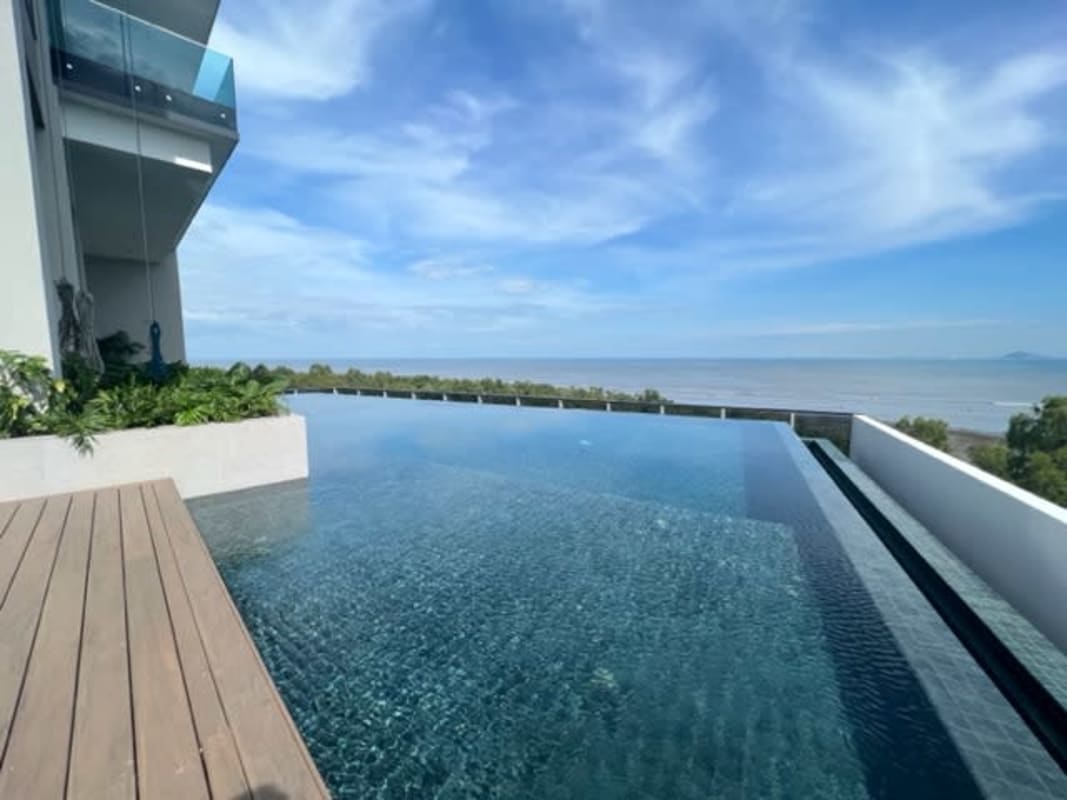 Infinity pool luxury deck overlooking ocean and Panama City skyline Upper East Tower Costa del Este