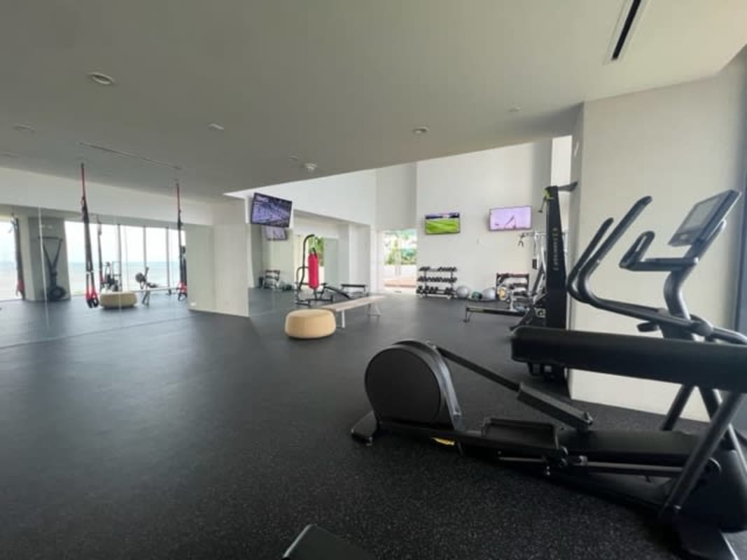 Fully equipped modern gym with floor-to-ceiling windows Panama skyline Upper East Tower Costa del Este