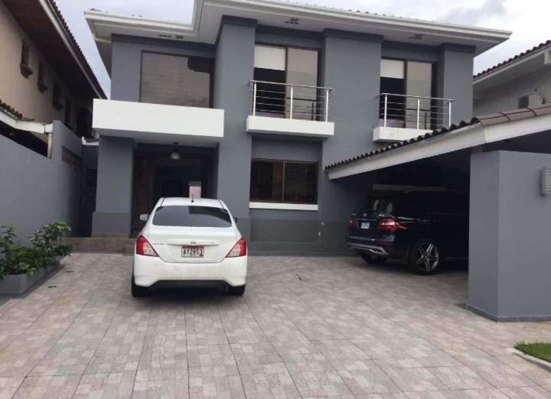 Spacious double-height living room with chandelier and stairs inside Home Altos de Panamá Panama City