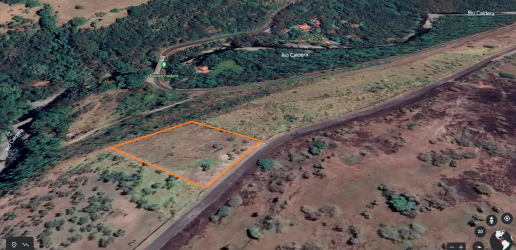 Vacant lot outlined with orange border adjacent to forest, river and access road near Boquete in Chiriquí, Panama