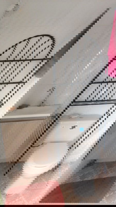 Bedroom with window metal bed frame tile flooring in Juan Diaz residential house Panama