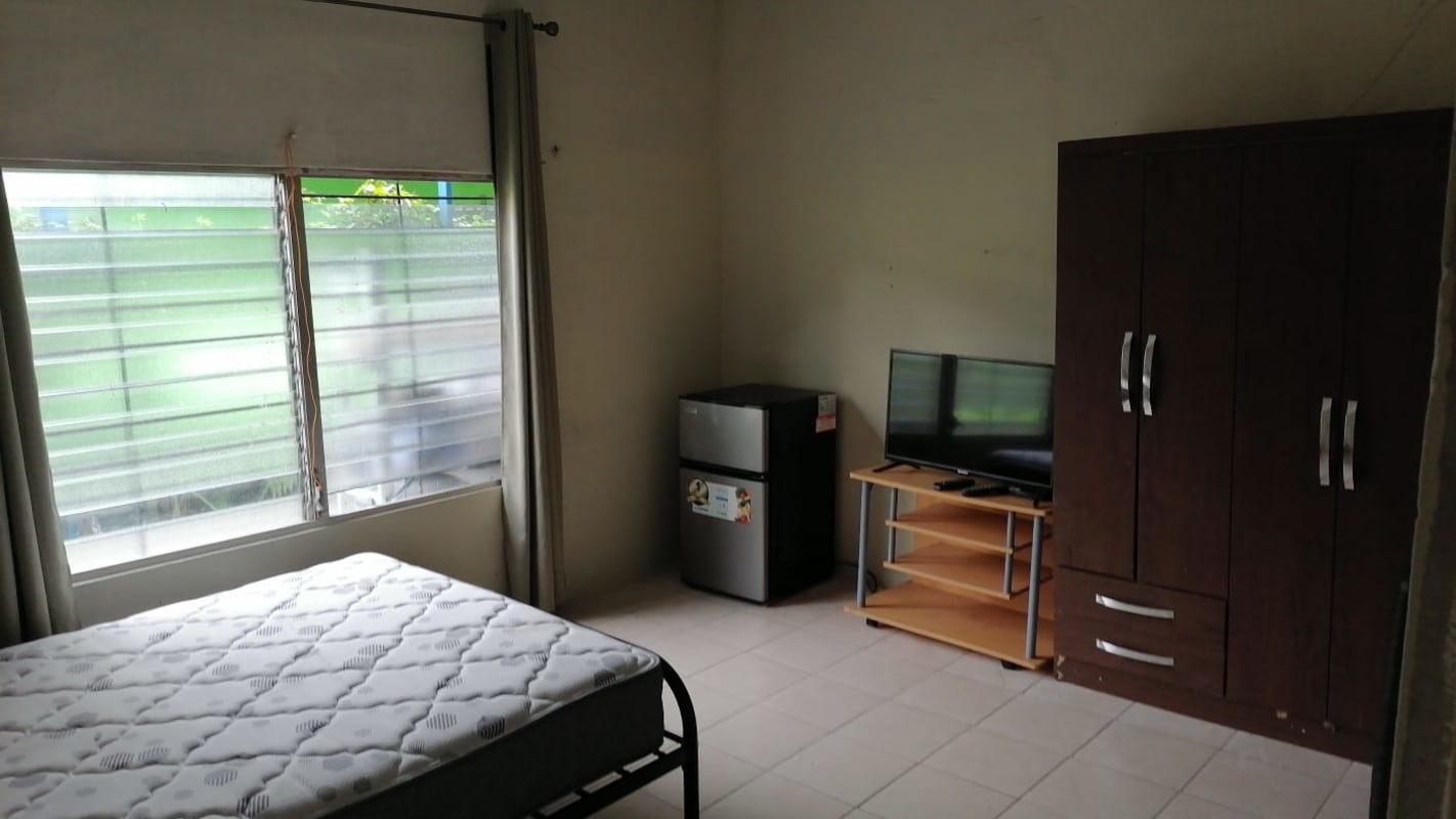 Small kitchen area with stove fridge in Ciudad Radial residential compound Panama City